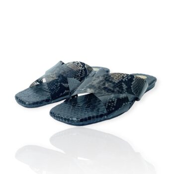 Black croc-embossed leather slides with translucent snake-print PVC crossover straps by Kieva Desuwa